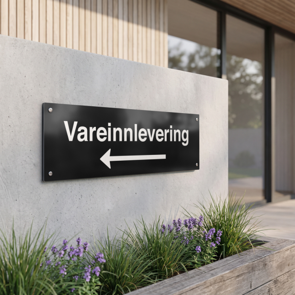 Vareinnlevering - svart henvisningsskilt med venstrepil, 150 x 500 mm 3 mm alu-sandwich